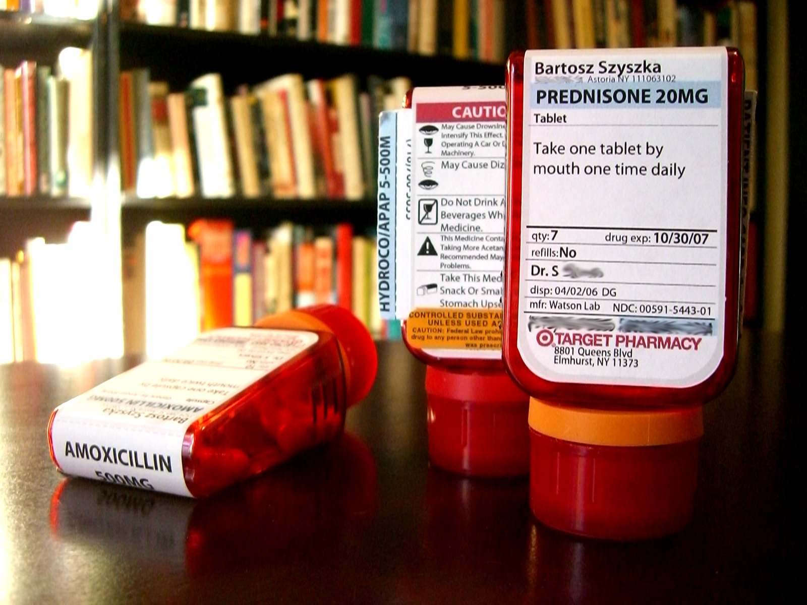 Several amber prescription bottles with pharmacy labels